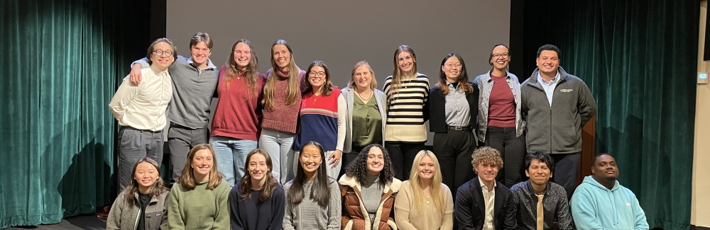 2024 SES Students sit on the stage at Cornelia Clapp Auditorium after their independent student symposium. 