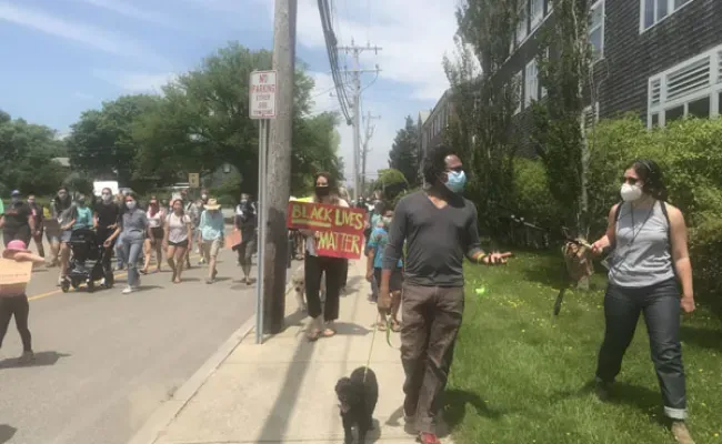 Andrew Fenton is interviewed by 'CAI's Even Zuckoff during the 2020 Black Lives Matter March in Woods Hole. Credit: Diana Kenney